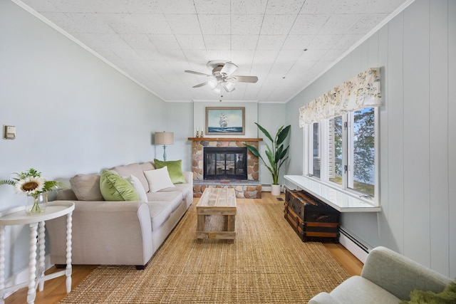 living room featuring ornamental molding, a baseboard radiator, and wood finished floors