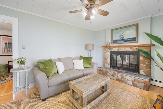 living room featuring a baseboard heating unit, a fireplace, ornamental molding, and wood finished floors