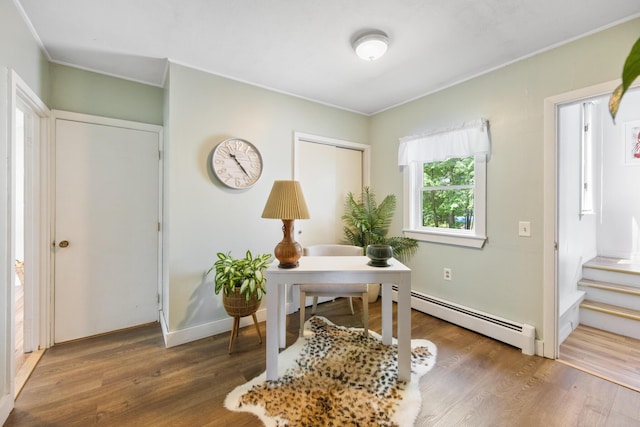 office featuring a baseboard radiator, crown molding, and wood finished floors