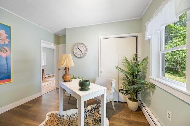 office area with dark wood-style floors, a baseboard radiator, and baseboards