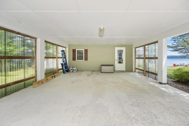 unfurnished sunroom with a water view