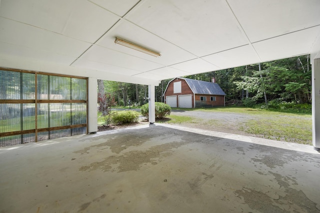 exterior space with a garage and an outbuilding