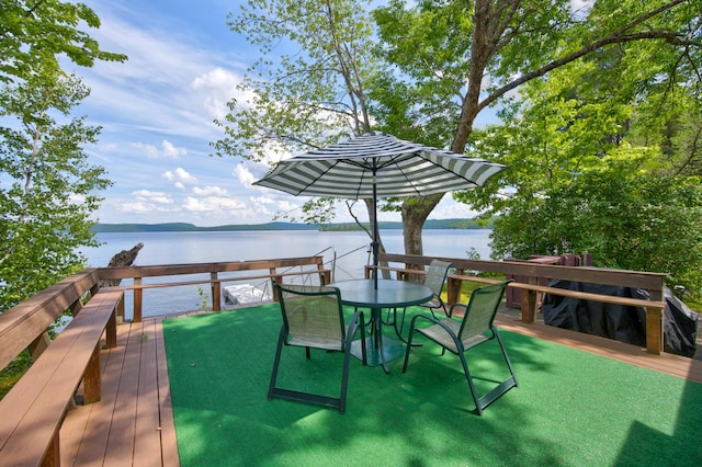 deck featuring a water view and outdoor dining space