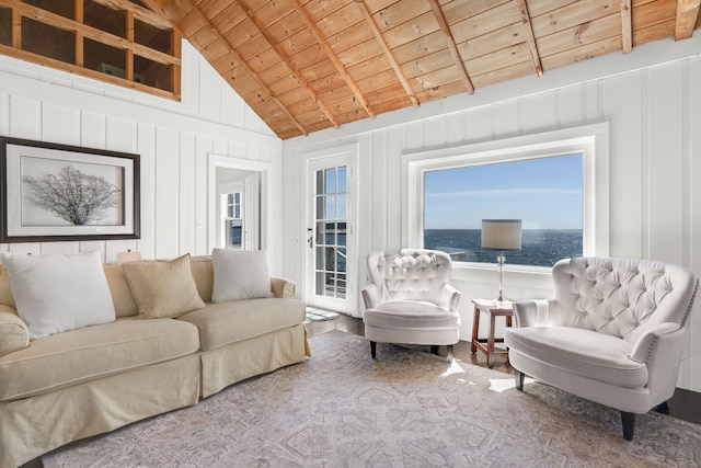 living area featuring lofted ceiling with beams and wooden ceiling