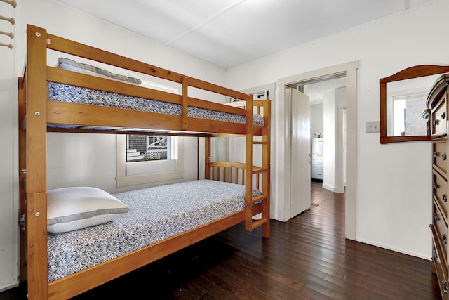 bedroom with multiple windows, baseboards, and hardwood / wood-style flooring