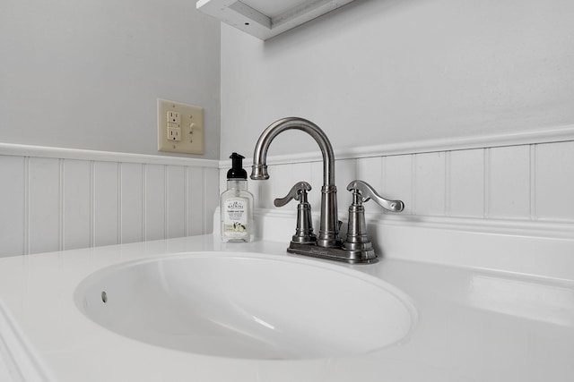 room details featuring a wainscoted wall and a sink