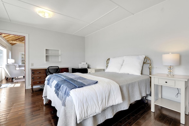 bedroom with dark wood-type flooring