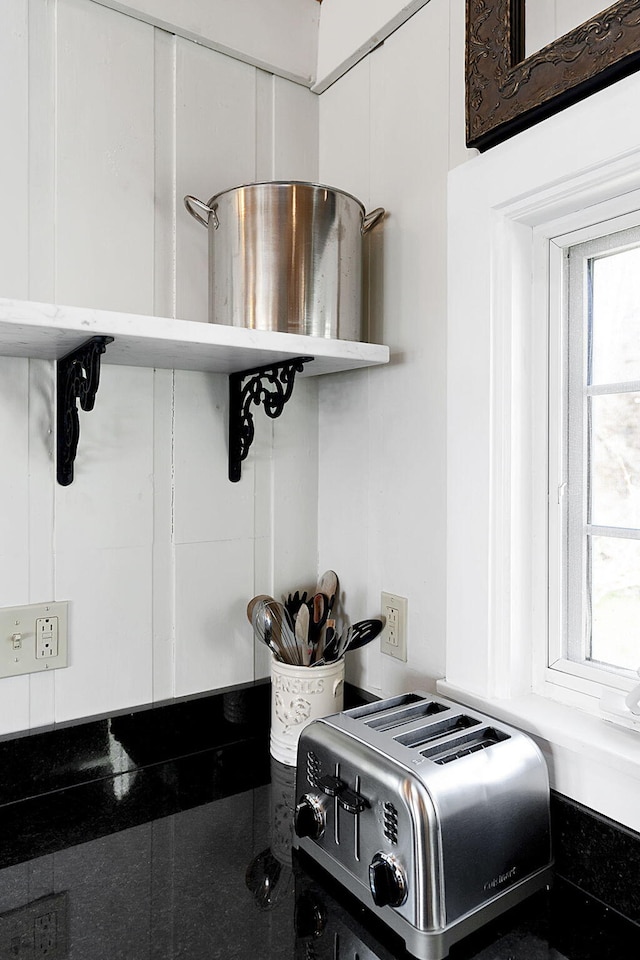 interior details featuring white cabinetry and a toaster