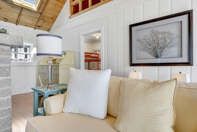 details with a skylight, a decorative wall, and wood finished floors