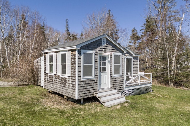 view of outdoor structure with entry steps and an outbuilding