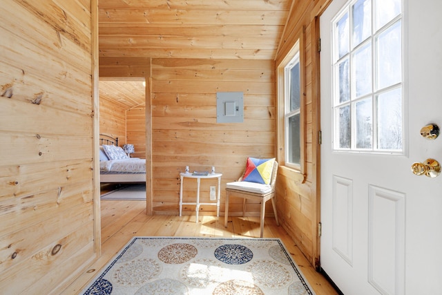 interior space with hardwood / wood-style floors, wood walls, and wood ceiling