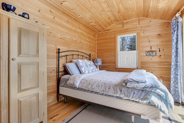 bedroom featuring wooden ceiling, wood walls, vaulted ceiling, and wood finished floors