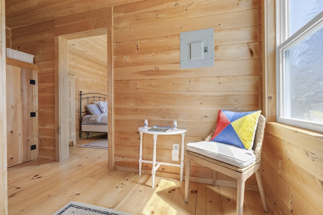 unfurnished room featuring wood walls and hardwood / wood-style floors