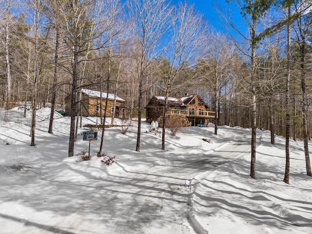 yard covered in snow with a wooden deck