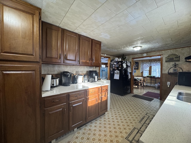 51 N Guilford Rd, Monson, ME 04464 - kitchen with freestanding refrigerator, light countertops, and light flooring