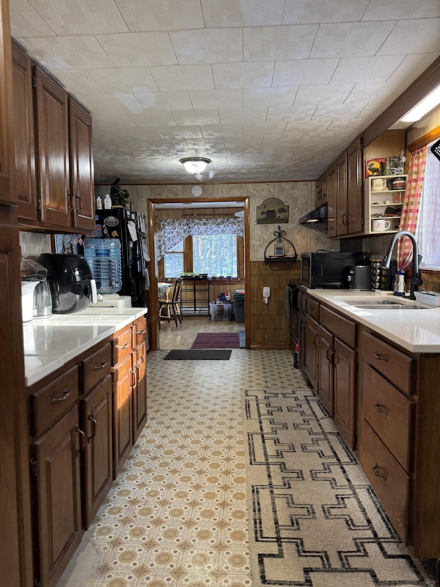 51 N Guilford Rd, Monson, ME 04464 - kitchen featuring light countertops, open shelves, light flooring, under cabinet range hood, and black microwave
