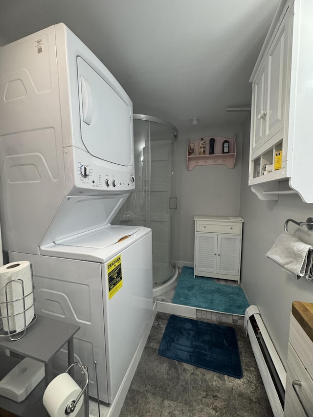 51 N Guilford Rd, Monson, ME 04464 - washroom with a baseboard heating unit and stacked washing machine and dryer