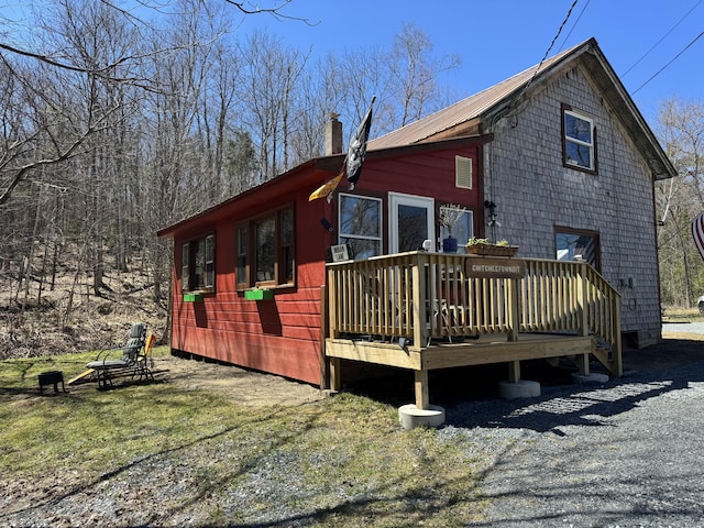 51 N Guilford Rd, Monson, ME 04464 - view of property exterior featuring a wooden deck and a chimney