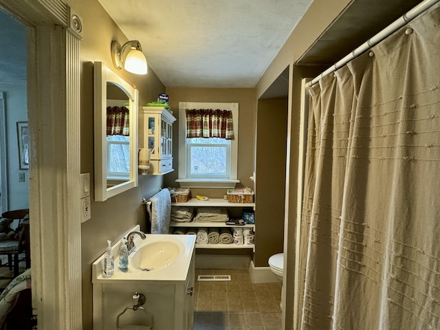 full bathroom with vanity, toilet, visible vents, and tile patterned flooring