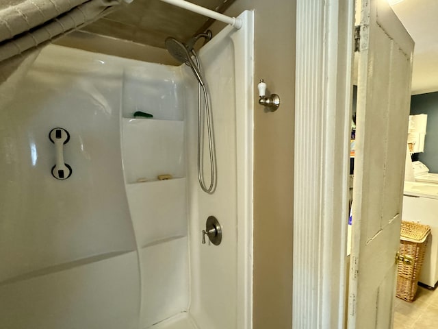 full bathroom featuring washer / clothes dryer and walk in shower