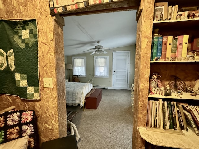 carpeted bedroom with baseboard heating, a ceiling fan, and vaulted ceiling