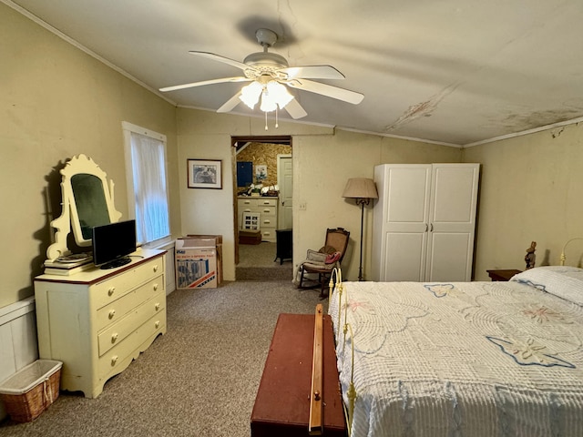 bedroom with a ceiling fan, carpet floors, and ornamental molding