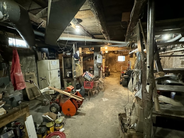 basement featuring plenty of natural light and freestanding refrigerator