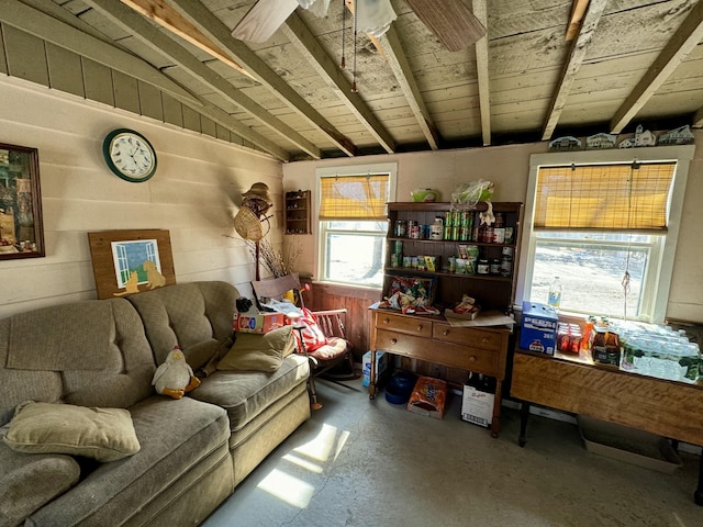 living room with wooden walls, concrete flooring, vaulted ceiling, wooden ceiling, and a ceiling fan