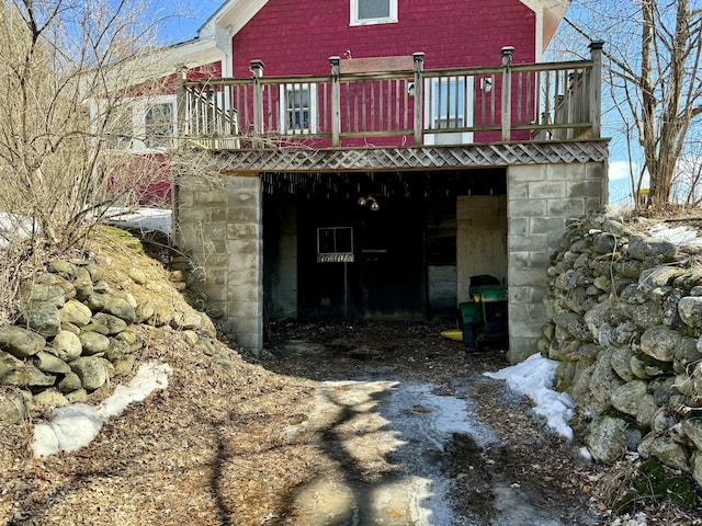 back of house with a deck and driveway