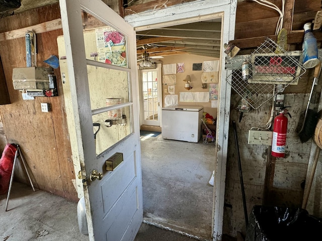 miscellaneous room with unfinished concrete flooring