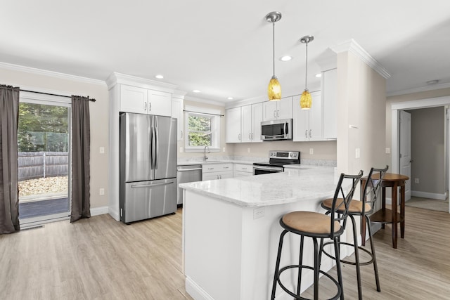 kitchen featuring a sink, crown molding, and stainless steel appliances