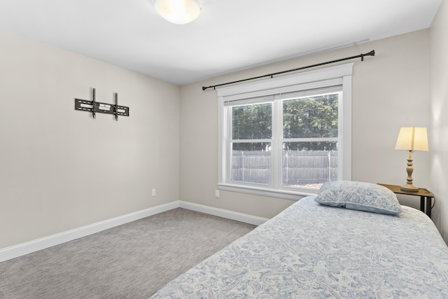 carpeted bedroom featuring baseboards