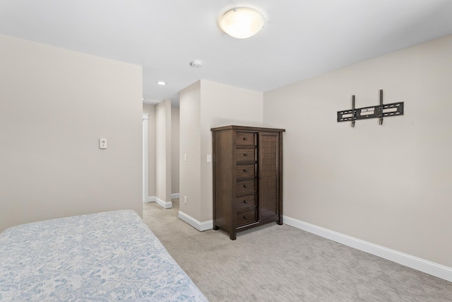 bedroom featuring recessed lighting, light colored carpet, and baseboards