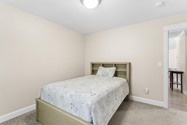 carpeted bedroom featuring baseboards