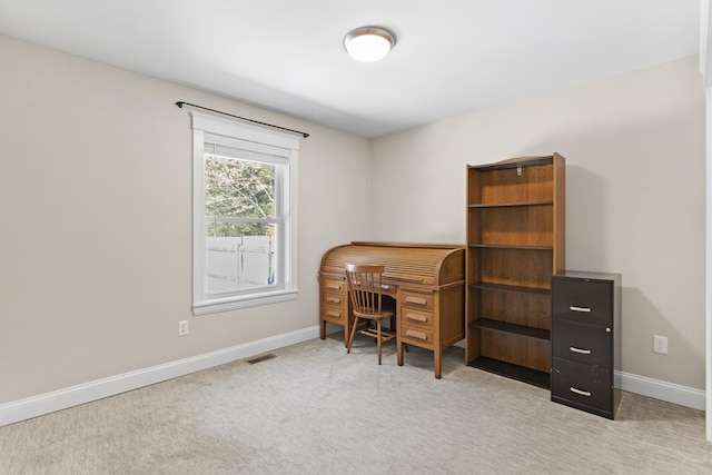 office area featuring light carpet, visible vents, and baseboards