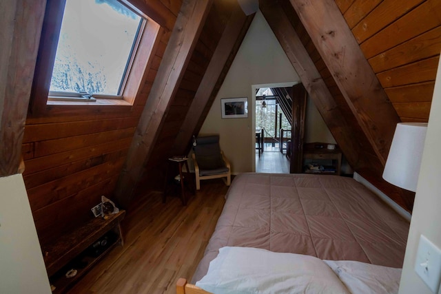 bedroom featuring lofted ceiling, wooden ceiling, wood walls, and wood finished floors