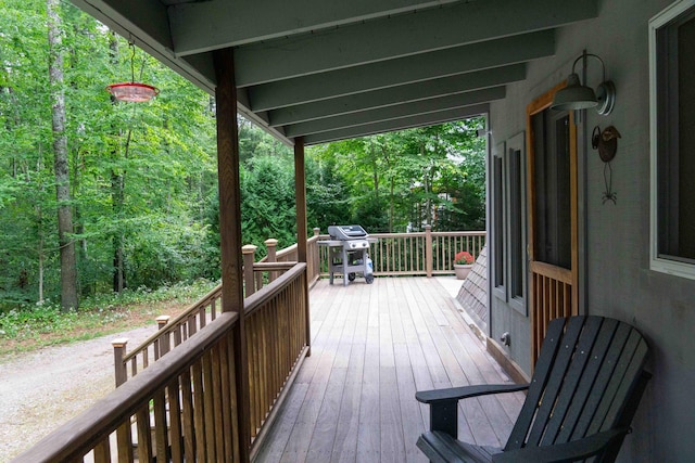 wooden terrace featuring a grill