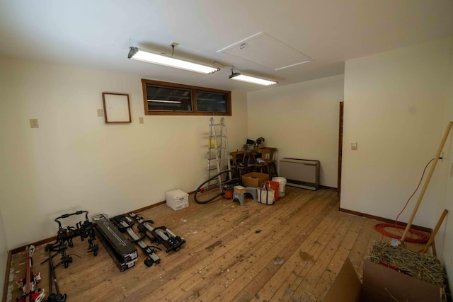 interior space with wood-type flooring, electric panel, and baseboards