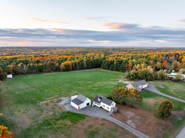 bird's eye view with a wooded view