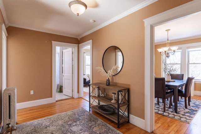 entryway with crown molding, baseboards, and wood finished floors