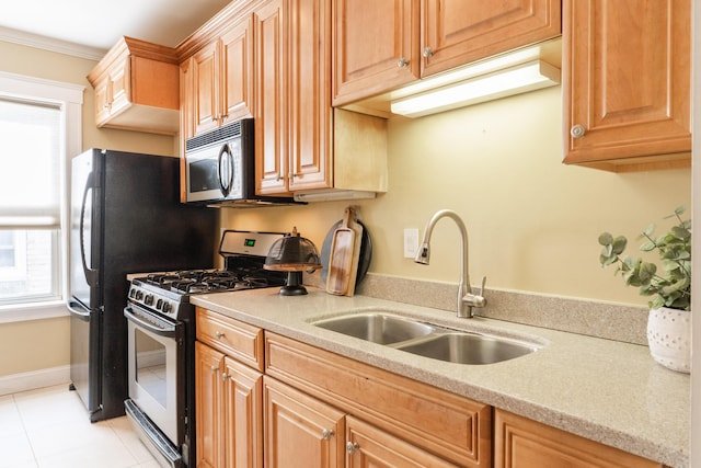 kitchen with light tile patterned floors, baseboards, stainless steel appliances, crown molding, and a sink