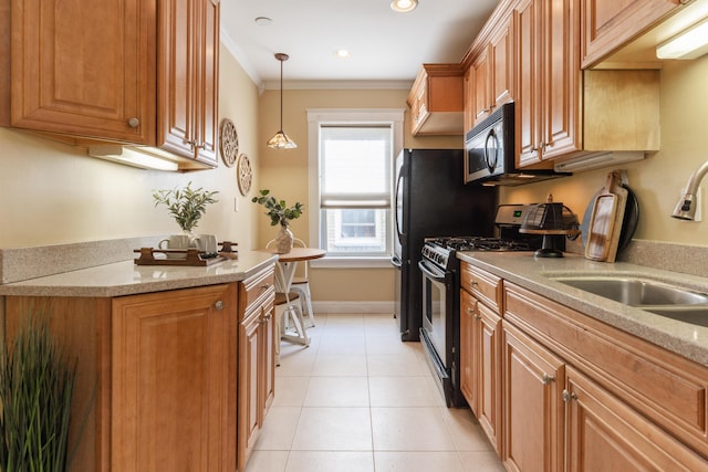 kitchen with light stone counters, stainless steel range with gas cooktop, light tile patterned floors, ornamental molding, and a sink