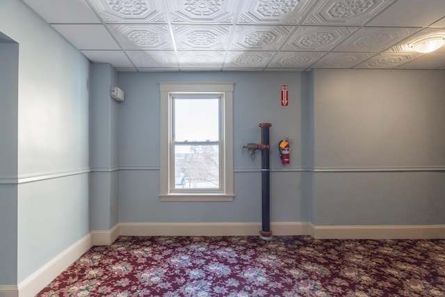 empty room featuring carpet flooring and baseboards