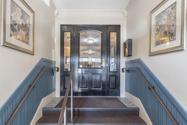 interior space featuring ornamental molding and wainscoting