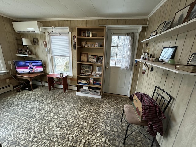 interior space featuring ornamental molding, a healthy amount of sunlight, a wall unit AC, and wood walls