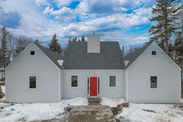 view of front of home featuring roof with shingles and a chimney