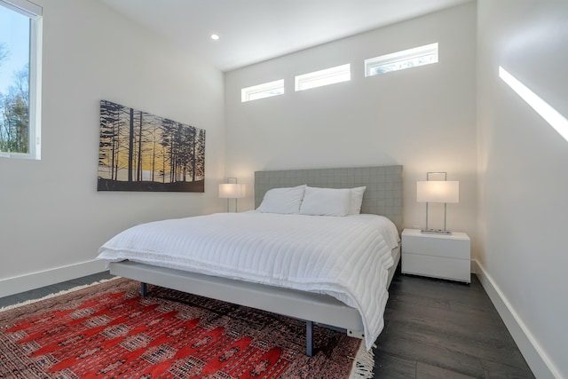 bedroom featuring recessed lighting, dark wood finished floors, and baseboards