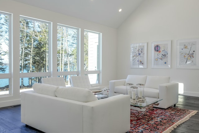 living room featuring lofted ceiling, dark wood-type flooring, recessed lighting, and baseboards