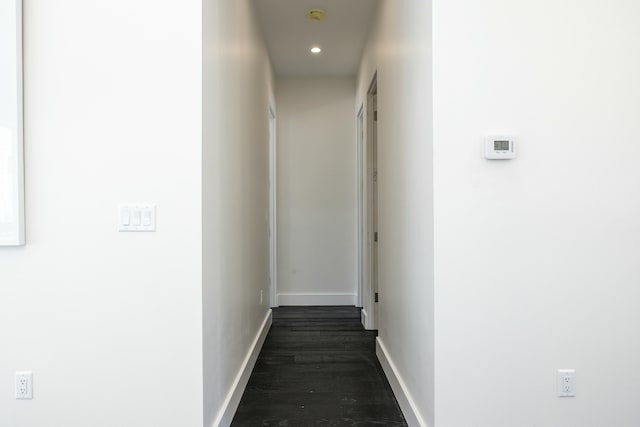 hallway with dark wood-style floors, recessed lighting, and baseboards