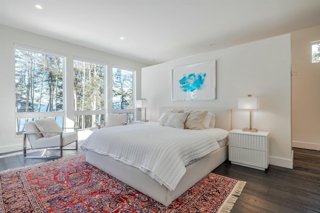 bedroom with dark wood-style flooring, recessed lighting, and baseboards